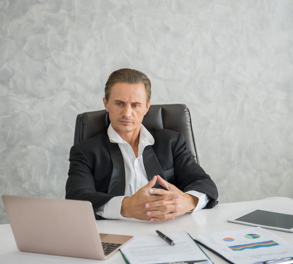 Serious businessman stressed out at work in office. fail busines Serious businessman stressed out at work in office. fail business concept.