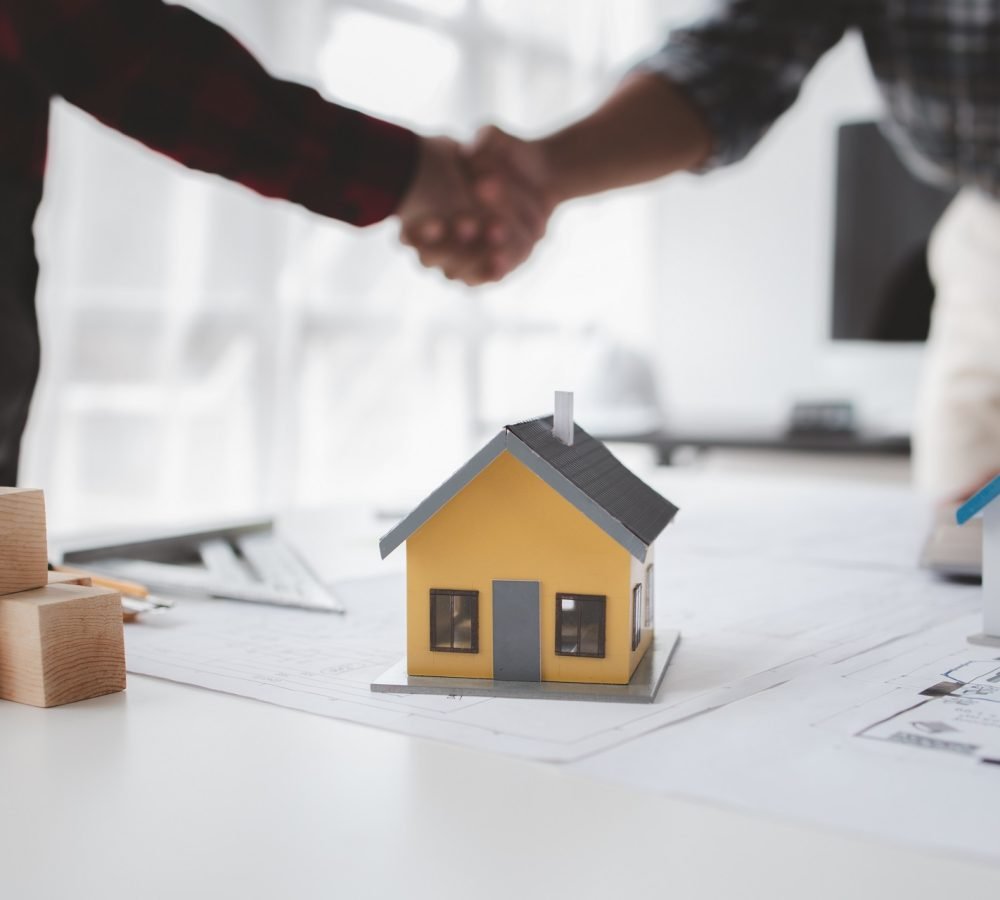 The home design architects are reviewing the house plan draft, the project commissioned by the client, and the custom design before delivery. Interior design and decoration ideas.